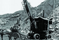 The power cord for the National Construction Equipment Museum’s Marion Model 21 Electric Shovel is visible on the ground behind it, and the AC/DC motor/generator that powers the motors can be seen inside the back doors.