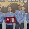 Walbro Japan staff members display their Supplier of the Year Award from Mitsubishi Heavy Industries.