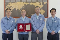 Walbro Japan staff members display their Supplier of the Year Award from Mitsubishi Heavy Industries.