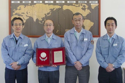 Walbro Japan staff members display their Supplier of the Year Award from Mitsubishi Heavy Industries.