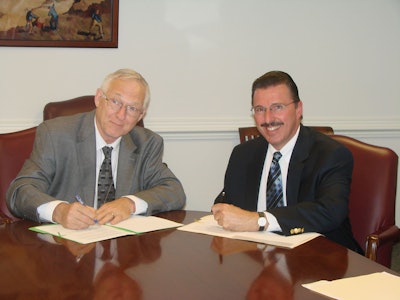 Assistant Secretary of Labor for MSHA Joseph Main (left) and AEM President Dennis Slater (right) at the signing.