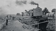 The Erie B was one of several models of steam shovels that could be modified for trench work. Note the spreader bar and shoring used to support the rails.