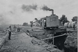 The Erie B was one of several models of steam shovels that could be modified for trench work. Note the spreader bar and shoring used to support the rails.