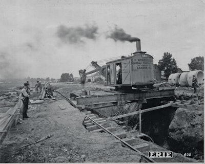 The Erie B was one of several models of steam shovels that could be modified for trench work. Note the spreader bar and shoring used to support the rails.
