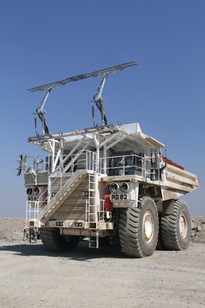 The Hitachi EH3500ACII operates via a trolley system in which voltage lines provide electrical power to the vehicle.