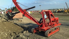 Powered by a Caterpillar crawler tractor, a steel-wheeled forty-foot industrial version of R.G. LeTourneau, Inc.'s Tractor Crane places roof beams during expansion of LeTourneau's Peoria, IL, offices in January, 1941.