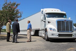 Peterbilt representatives Don Vollmar (left) and Rick Mihelic (right) present the advanced concept SuperTruck vehicle for U.S. Rep. Michael C. Burgess, M.D. (center).