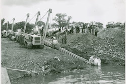 The ability of sidebooms and pipelayers to walk with a long strand of pipe makes possible a project like this. Bechtel Corporation is walking a 600-foot strand of pipe into the Niagara River for the Tennessee Gas Transmission Company on September 11, 1954. This was the first pipeline to cross the Niagara, and a fleet of Cat MD7s, equipped with extra counterweights, is doing the honors. The MD7 was a very popular sideboom; fleets of them still turned up in pipeline auctions into the early 2000s.