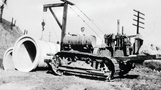 The problems involved in placing pipe with an end boom are illustrated by this rather crude rig, designed by R. G. LeTourneau for a Cat Sixty and used by his construction company on the grading contract for Southern Pacific Railroad's Carquinez Bridge approach in Benicia, CA, in 1929. Ballasted by sandbags, it provided ample capacity for a single section of pipe, but was unable to carry long strands along the trench.
