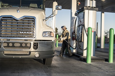 A driver fuels a Mack Pinnacle Axle Back model.