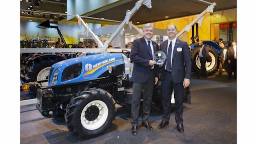 New Holland executives display the Tractor of the Year 2015 award in front of the T3F.