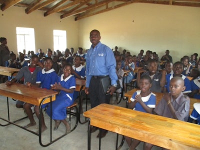 Bendix’s Martin M. M’Tambo recently returned to Kawale Primary School, which he attended as a young boy, to celebrate the completion of a classroom-construction project that he had conceived and directed under the auspices of Knorr-Bremse Global Care.