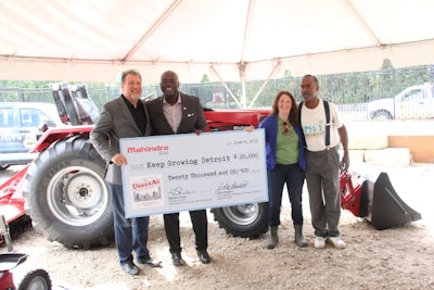 Mahindra executives Rick Haas and Cleo Franklin (left) present one of the company's five urban agriculture grants to Keep Growing Detroit's Ashley Atkinson and Willie Spivey (right).