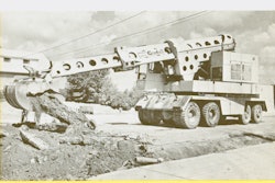 A Warner & Swasey G1000 Gradall demonstrates the telescopic excavator’s ability to break up and remove pavement.