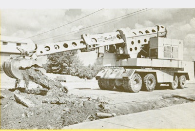 A Warner & Swasey G1000 Gradall demonstrates the telescopic excavator’s ability to break up and remove pavement.