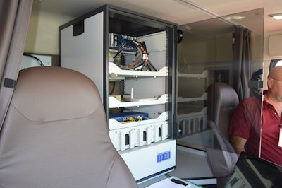 The sleeper compartment of the Volvo VHD 430 serves as the information hub, gathering data from various sensors and an in-cab video camera and matching it with satellite positioning data. One technician controls and monitors the instrumentation by laptop while another drives.