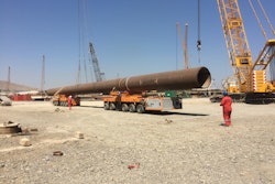 Handling huge pipes with the KAMAG K24 during an on-site transport; bolsters with 300 tons payload are used to safely fix the load.
