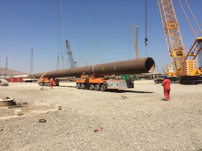 Handling huge pipes with the KAMAG K24 during an on-site transport; bolsters with 300 tons payload are used to safely fix the load.
