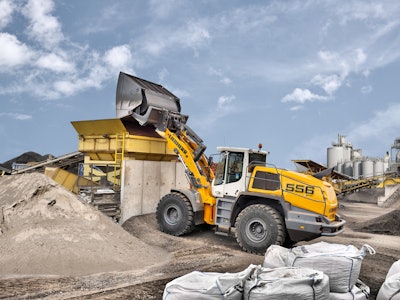 The Liebherr L 556 XPower wheel loader with industrial lift arms and high-dump bucket in test operation at a recycling business.