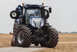 NewHolland T8 NHDrive Autonomous Concept Tractor on private farm track with the New Holland 2085 Air Disc Drill in transport position entering the field 57c6dba291640