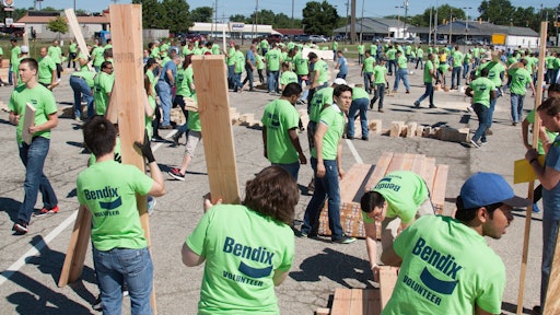 Nearly 500 Bendix volunteers gathered at the company’s headquarters in Elyria June 24, building frames for four Habitat for Humanity homes.
