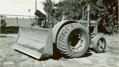 The ancestor of all wheel dozers is this diminutive machine, a John Deere D farm tractor outfitted in 1936 with an experimental blade designed by R. G. LeTourneau.