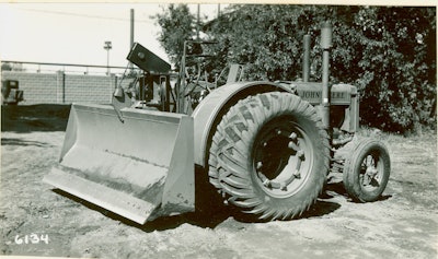 The ancestor of all wheel dozers is this diminutive machine, a John Deere D farm tractor outfitted in 1936 with an experimental blade designed by R. G. LeTourneau.