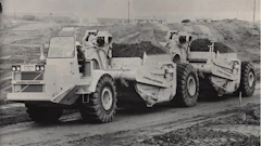 A LeTourneau-Westinghouse C-500 prime mover with two unpowered scrapers.
