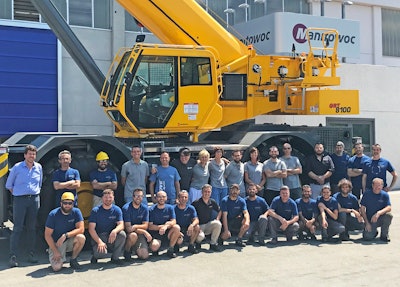 The Manitowoc employees who supported the project and workers from the assembly line in front of the first GRT8100 produced in Manitowoc’s factory in Niella Tanaro, Italy.