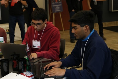 l to r: Jared Lobo and Sohail Kahn working diligently together for their team challenge.