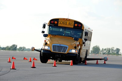 A vehicle on a demonstration track where the stability system is turned off. Outriggers are installed during demonstrations to keep the vehicle from rolling over.