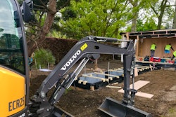 The electric excavator digging the foundations of the garden’s main structure.