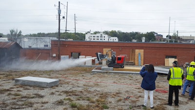 The facility incorporates an outdoor proving ground with various concrete structures to prove out the power and precision of Brokk and Aquajet products, including simulated Department of Transportation materials and steel reinforcement configurations.