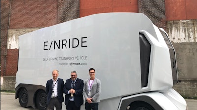 Michelin and Einride executives in front of the autonomous electric truck at the Movin'On Summit.
