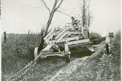 Tree removal wasn’t a typical application for a pull grader, but Rome Manufacturing demonstrated the robust construction of one of its larger graders by having it uproot a roadside tree without suffering distortion or damage.