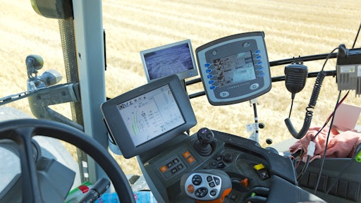 Figure 1: New agricultural tractor cabins are equipped with electronic controls and multiple displays.