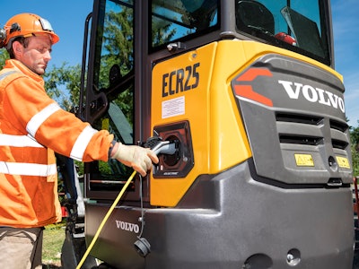 Spac operator Alexandre Birot plugs in the Volvo ECR25 Electric for recharging.
