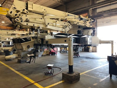 Schwing readies a concrete boom pump for integration on a Mack chassis.