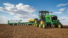 The John Deere 8RX tractor features four tracks which help to minimize soil compaction while moving through a field.
