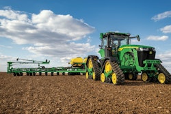The John Deere 8RX tractor features four tracks which help to minimize soil compaction while moving through a field.