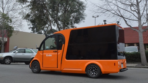 The udelv last-mile delivery vehicle operates autonomously and is supervised by a safety driver.