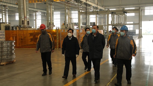 SDLG CEO and Chairman Wang Zhizhong and top SDLG executives monitor the measures put in place to ensure the health and safety of employees as SDLG’s factory reopens.