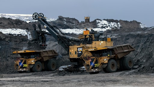 Two Cat 797 F Autonomous Trucks Being Loaded In Pit