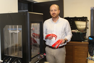 A Terex team member helps print parts for face shields produced on the company’s 3D printer.