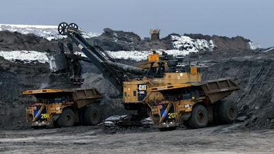 Two Cat 797 F Autonomous Trucks Being Loaded In Pit