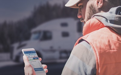A professional driver changes duty status on the Geotab Drive app, which works with the new Geotab Drive + Fleet for Volvo Trucks.