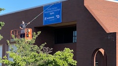 Unfurling of a banner on the Sheppard building denoting it is now part of Bendix Commercial Vehicle Systems.