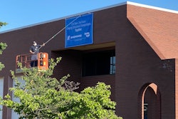 Unfurling of a banner on the Sheppard building denoting it is now part of Bendix Commercial Vehicle Systems.
