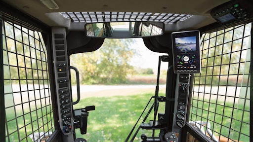 The Case B Series display includes a backup camera visible in a split screen along with machine data.