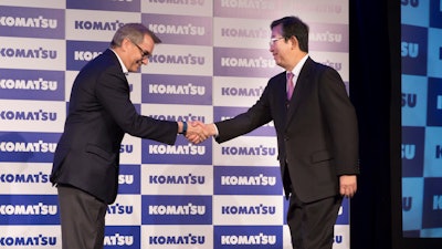 Komatsu Mining Corp. President and CEO Jeffrey Dawes (left) shakes hands with Komatsu Ltd. President and CEO Tetsuji Ohashi upon the completed rebranding of Joy Global after it was acquired by Komatsu.